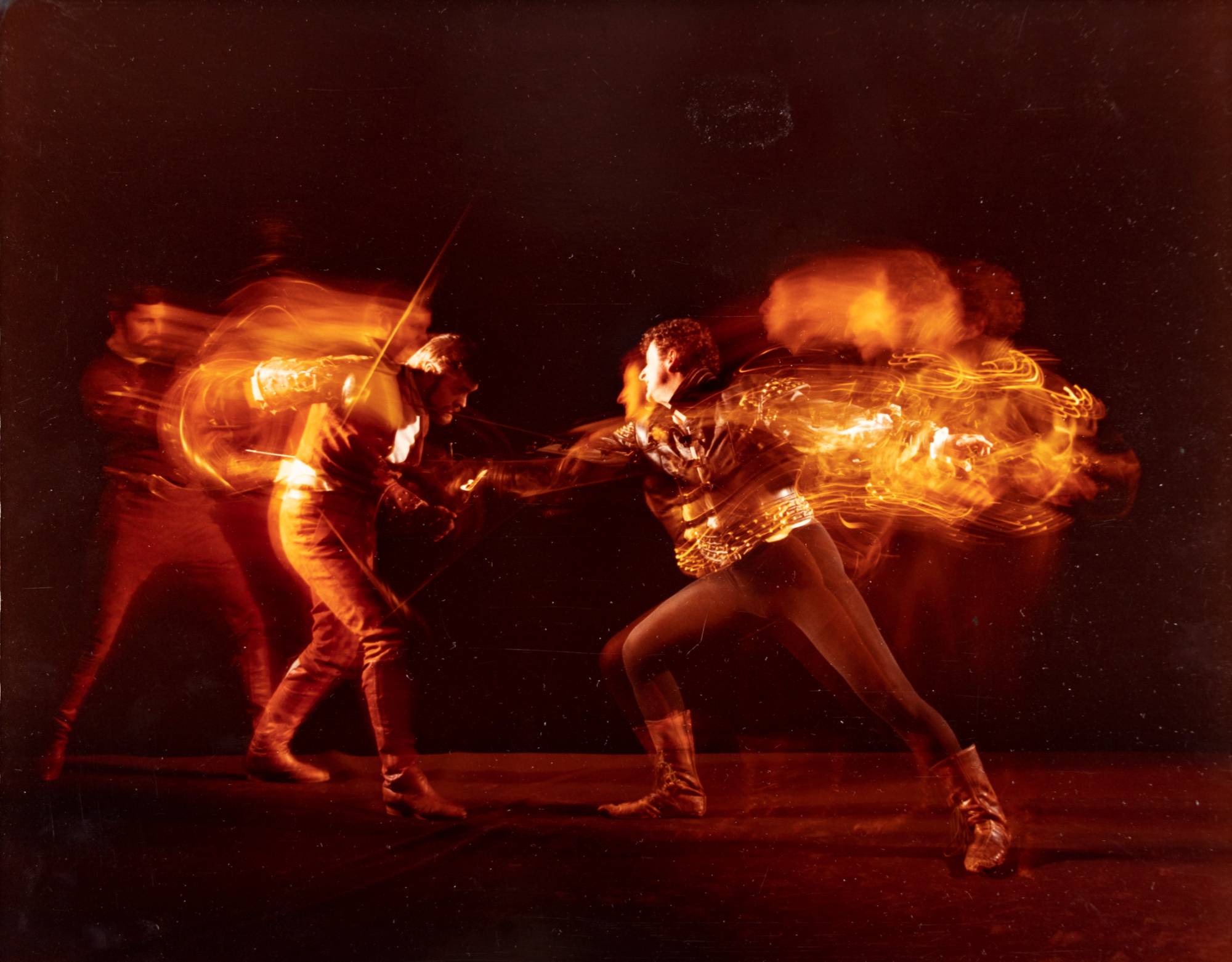 two fencers in a blur of motion